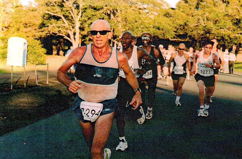 Mal, an older man running with sunglasses, in the lead in the Host City Marathon